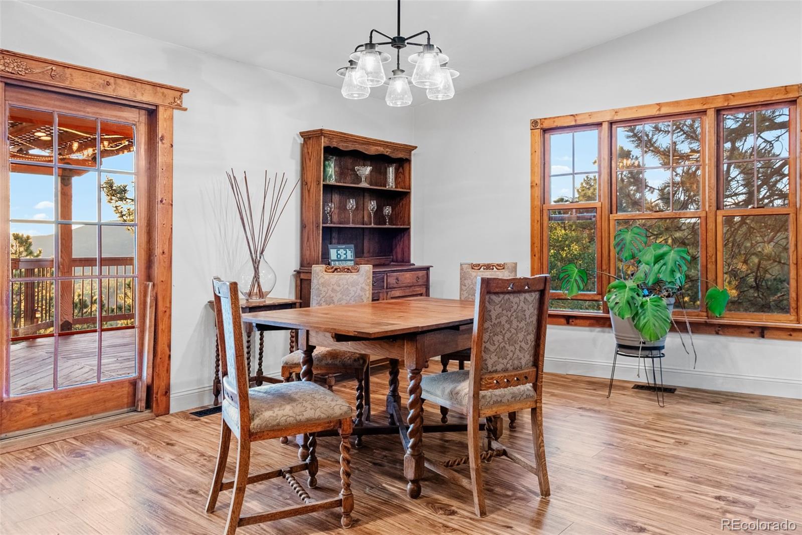 8440 South Warhawk Road Conifer, CO 80433 - Photo 15 of 48 a view of a dining room with furniture window and wooden floor