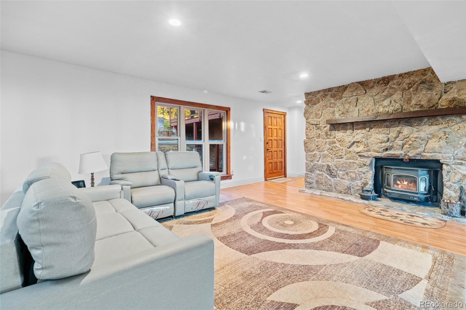 8440 South Warhawk Road Conifer, CO 80433 - Photo 29 of 48 a living room with furniture and a fireplace