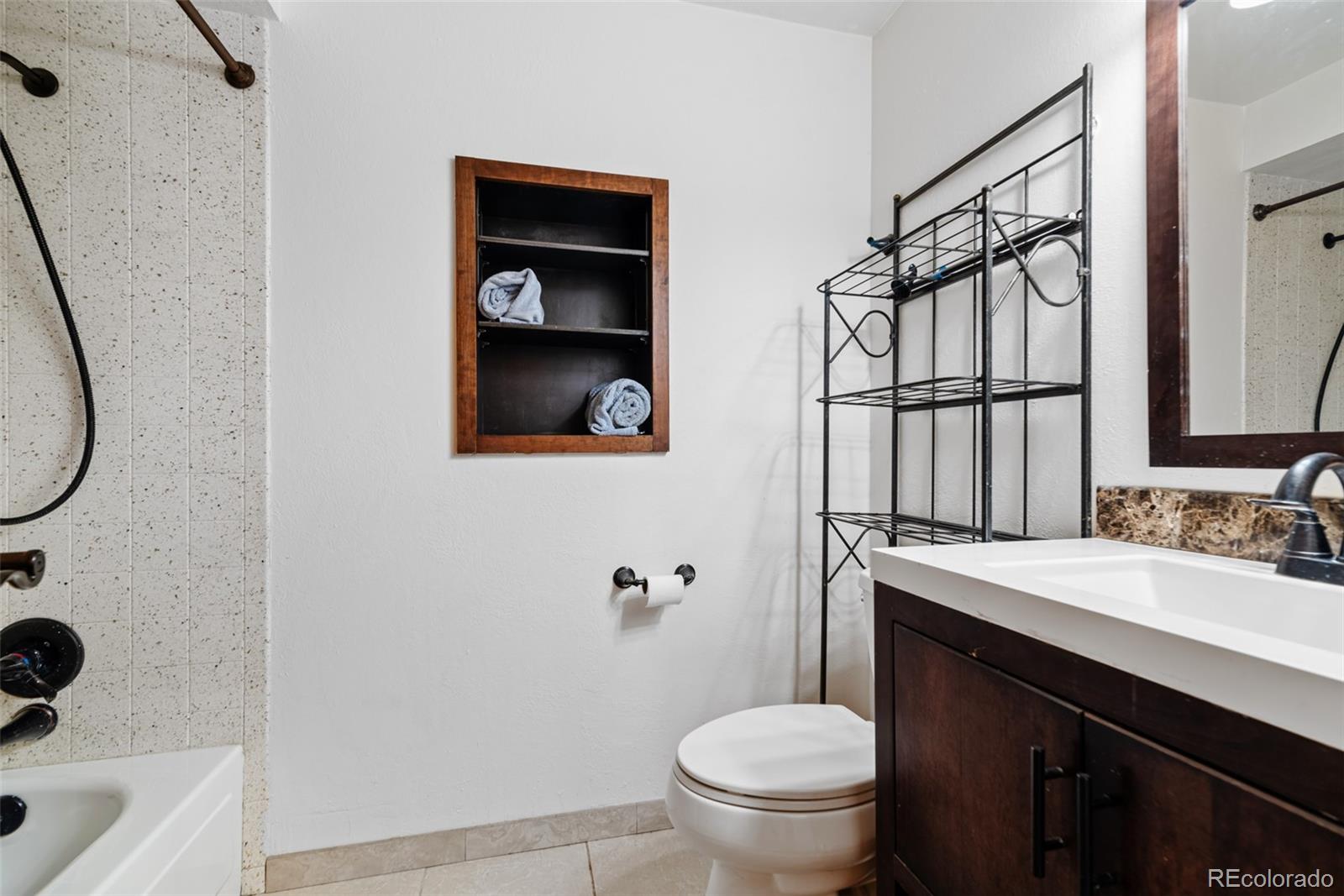 8440 South Warhawk Road Conifer, CO 80433 - Photo 32 of 48 a bathroom with a sink toilet and shower
