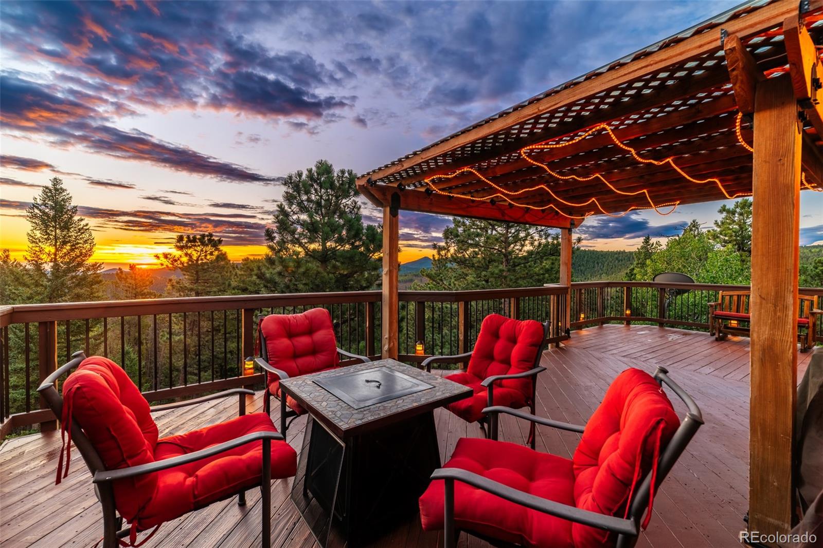 8440 South Warhawk Road Conifer, CO 80433 - Photo 4 of 48 a roof deck with a table and chairs