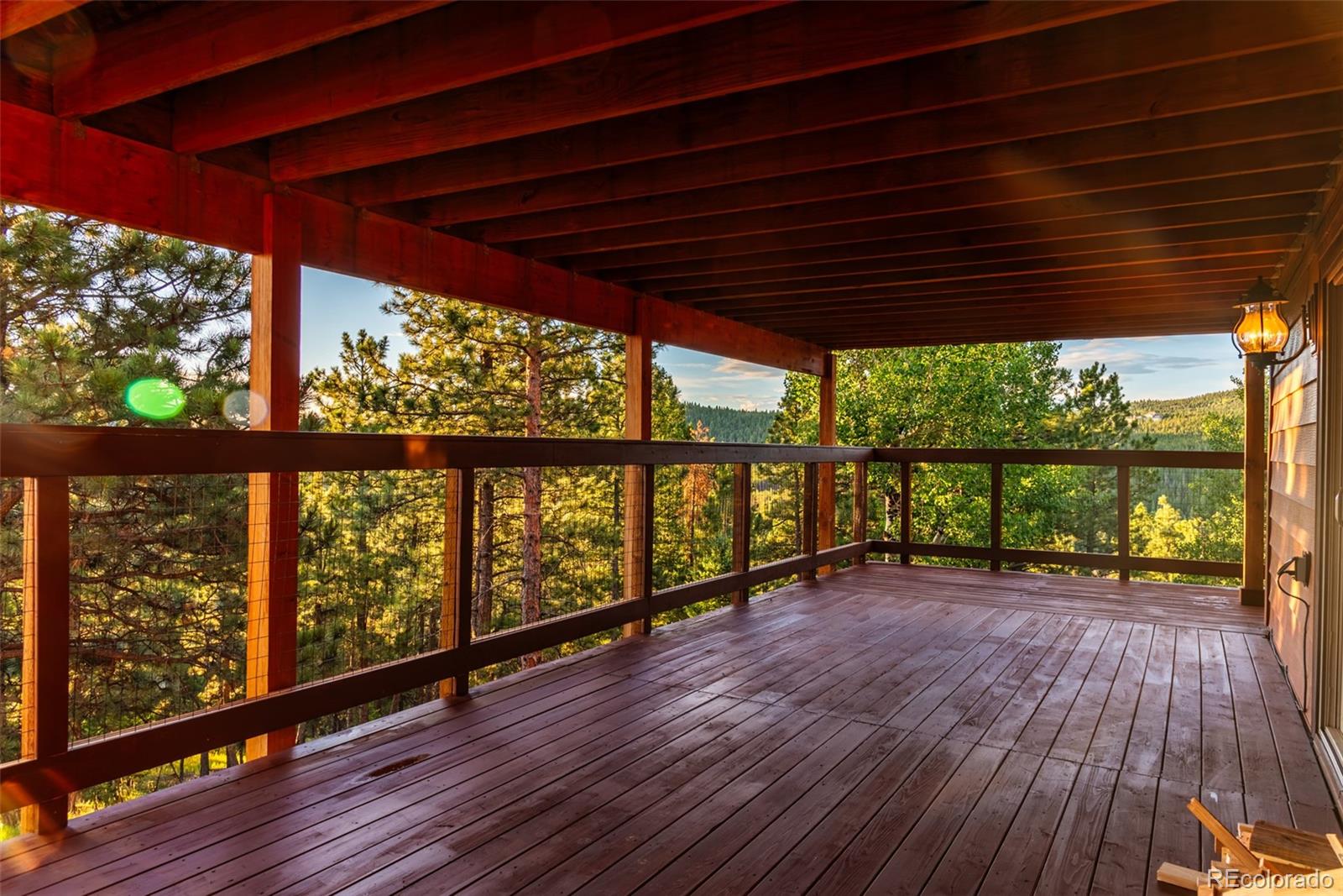 8440 South Warhawk Road Conifer, CO 80433 - Photo 44 of 48 a view of porch with wooden floor in outdoor space