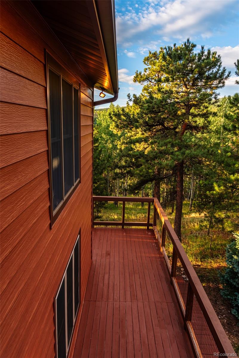 8440 South Warhawk Road Conifer, CO 80433 - Photo 46 of 48 a view of balcony with wooden floor and fence