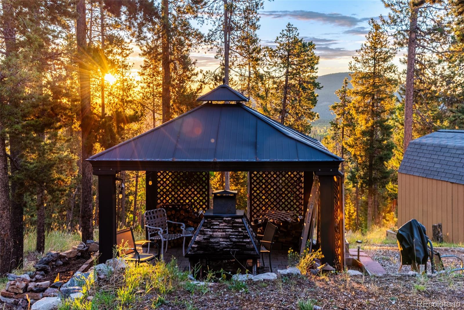 8440 South Warhawk Road Conifer, CO 80433 - Photo 9 of 48 a view of a house with backyard porch and sitting area