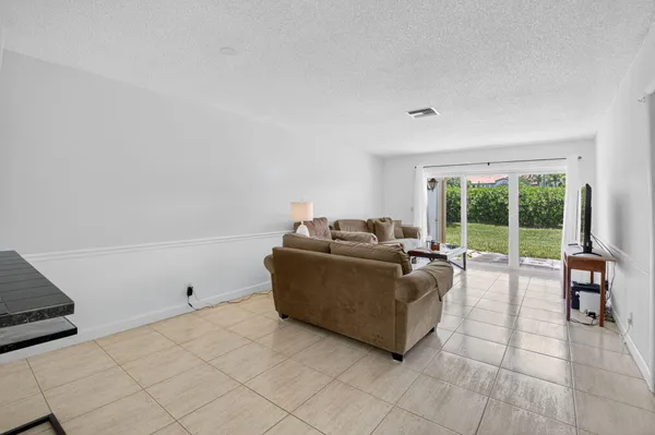a living room with furniture and large window