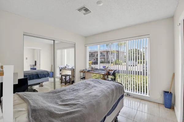 a bedroom with a bed and a large window