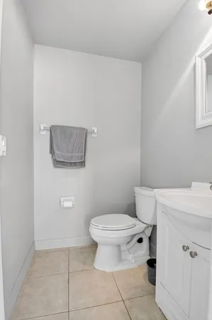 a bathroom with a toilet a sink and a mirror