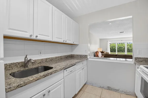a kitchen with a sink cabinets and window