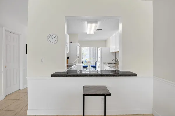 a bathroom with a granite countertop sink a mirror and a shower