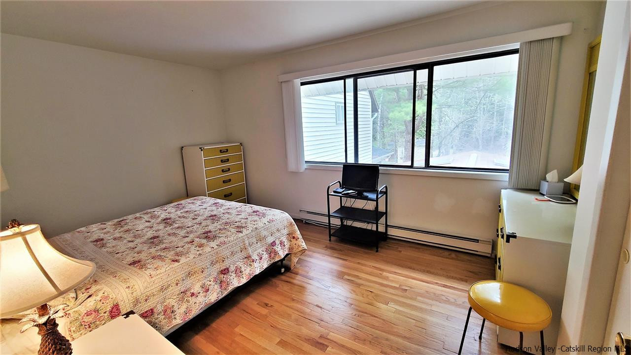 52 Medallion Road Kiamesha Lake, NY 12751 - Photo 15 of 31 a bedroom with a bed and a chair