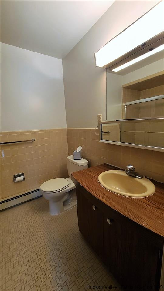 52 Medallion Road Kiamesha Lake, NY 12751 - Photo 17 of 31 a bathroom with a granite countertop toilet a sink and mirror