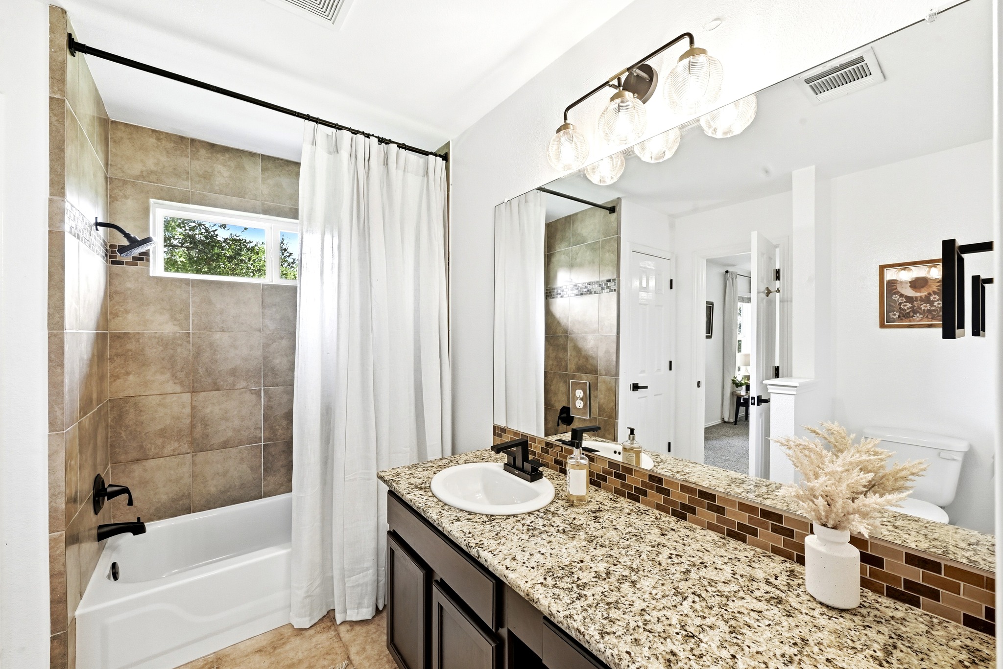 1801 Monks Tale Court Austin, TX 78748 - Photo 18 of 36 Granite counters and tiled shower walls create a polished, functional space.