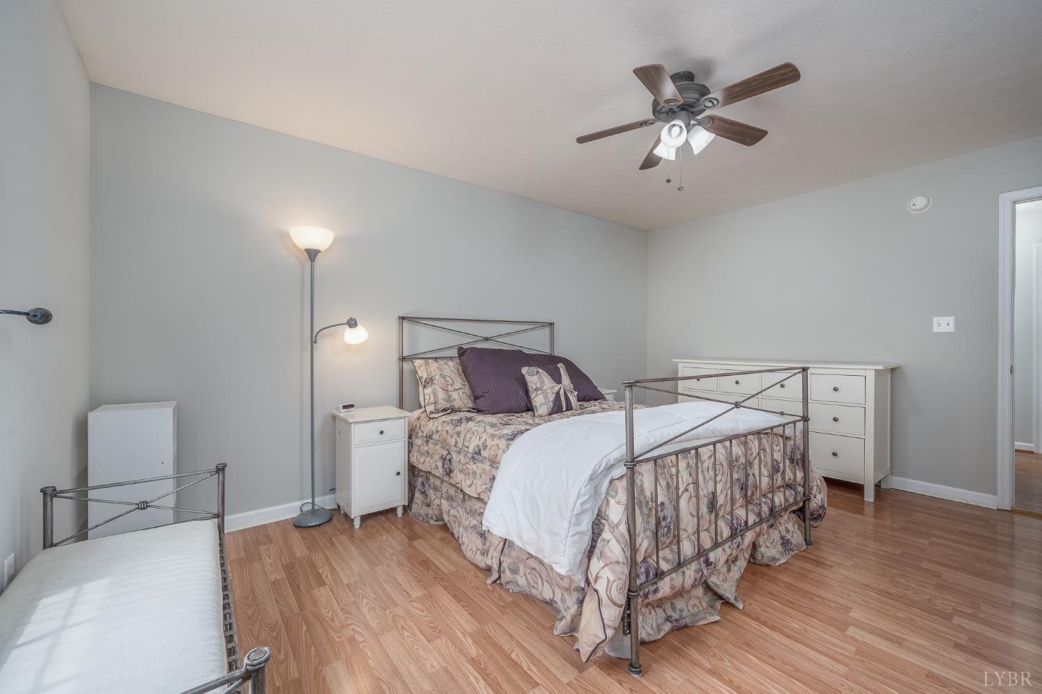 7179 Stage Road Concord, VA 24538 - Photo 14 of 52 a bedroom with a bed and a chandelier