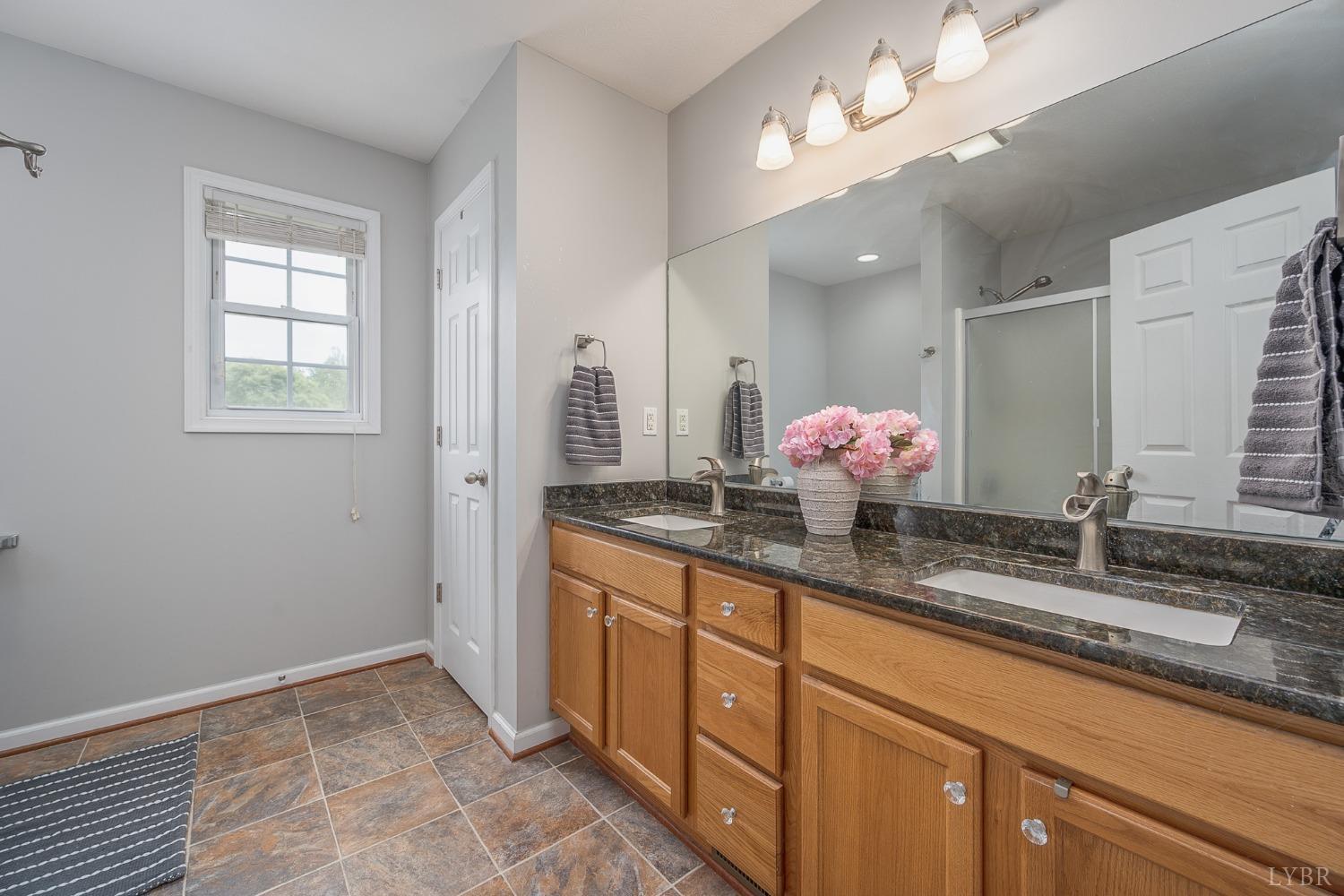 7179 Stage Road Concord, VA 24538 - Photo 16 of 52 a bathroom with a double vanity sink and a mirror