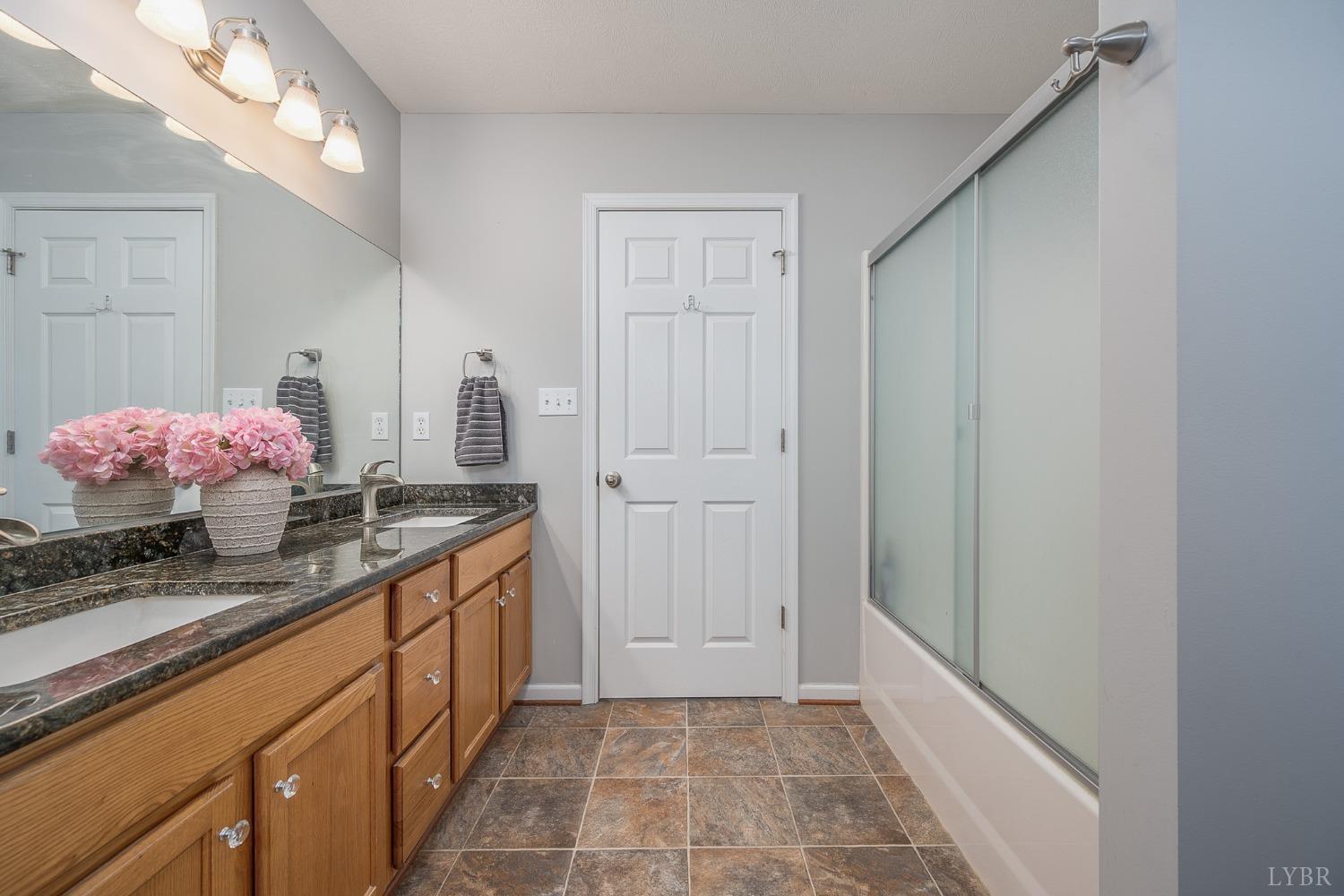 7179 Stage Road Concord, VA 24538 - Photo 17 of 52 a bathroom with granite countertop a sink and a mirror