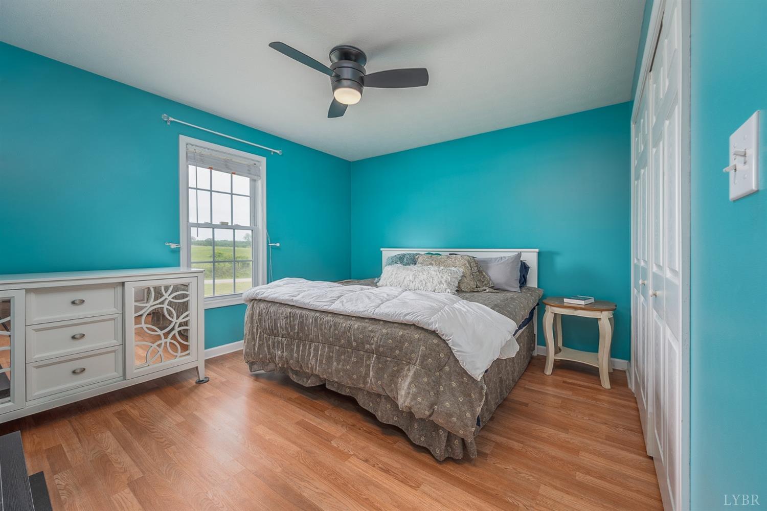 7179 Stage Road Concord, VA 24538 - Photo 18 of 52 a bedroom with a bed a dresser and a window
