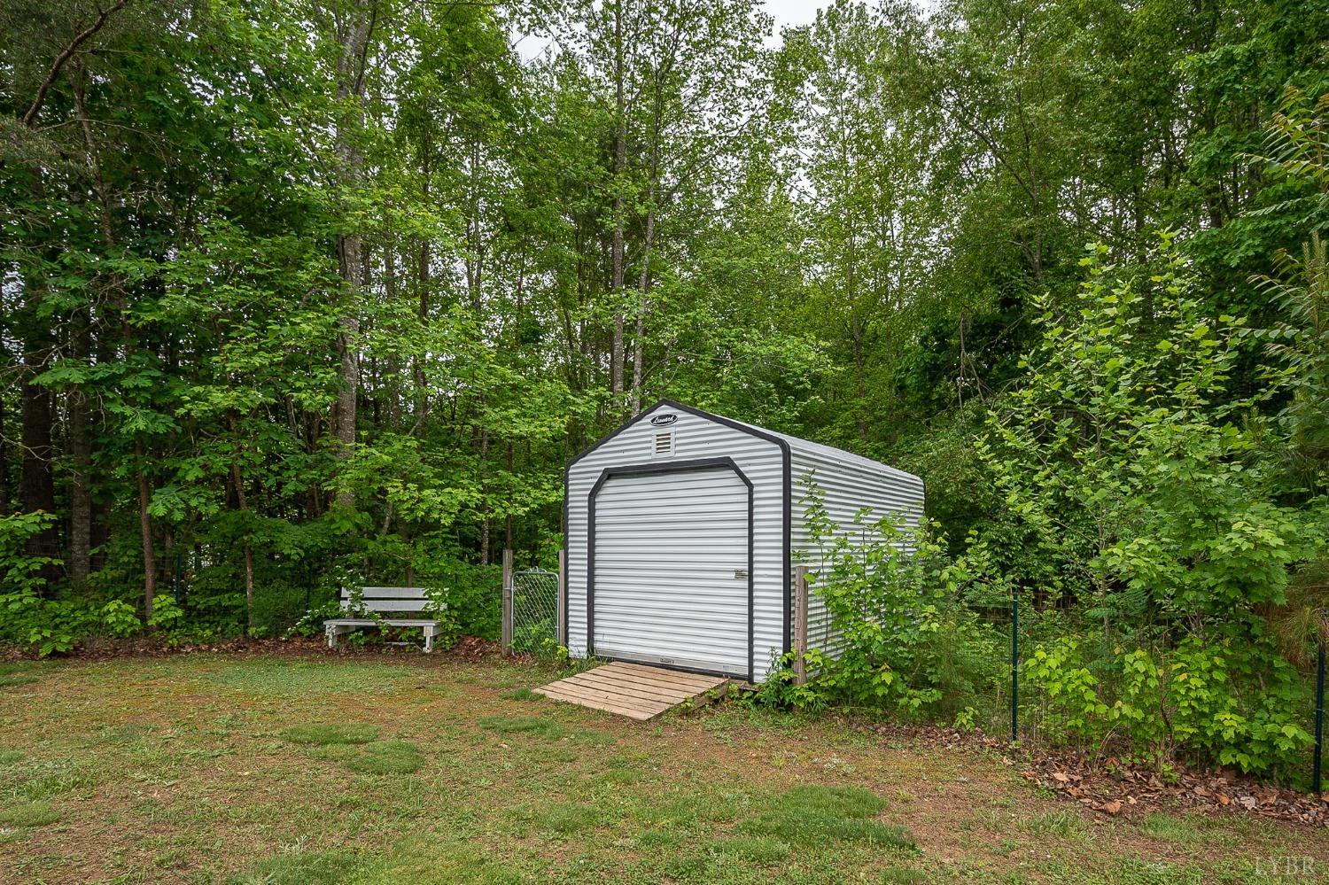 7179 Stage Road Concord, VA 24538 - Photo 38 of 52 a front view of a house with a yard and trees