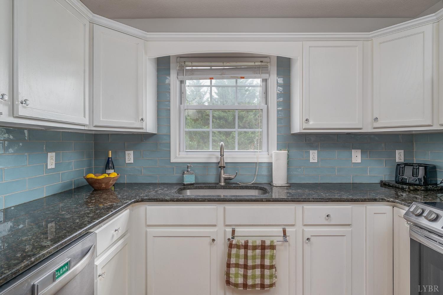 7179 Stage Road Concord, VA 24538 - Photo 10 of 52 a kitchen with stainless steel appliances granite countertop a sink a stove cabinets and a window