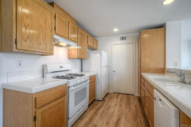 a kitchen with a sink stove and refrigerator