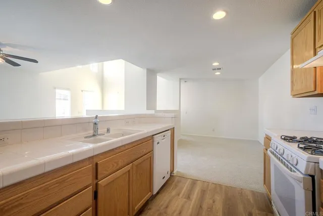 a kitchen with a sink stove and cabinets