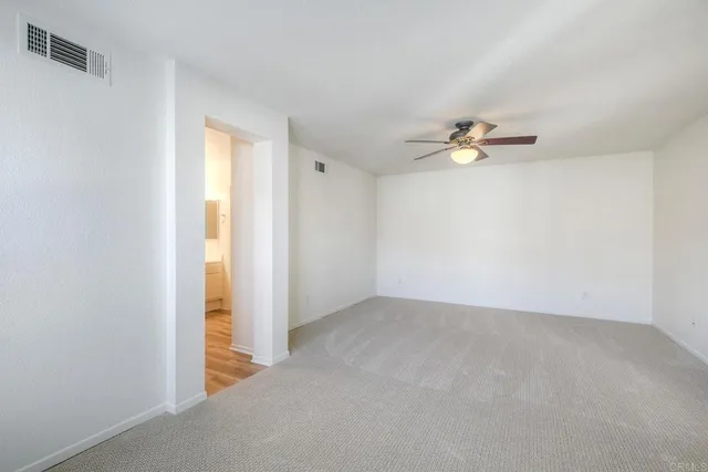 a view of an empty room with a fan