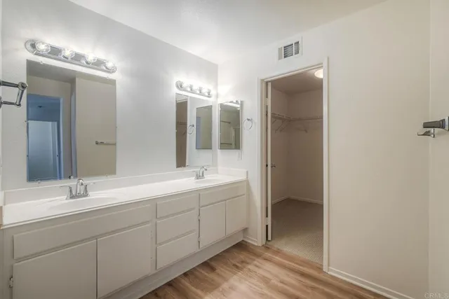 a bathroom with a double vanity sink mirror and double