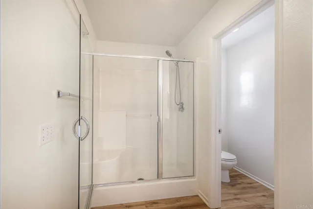 a bathroom with a shower and a toilet
