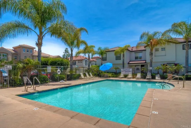 a view of a swimming pool with a table and chairs