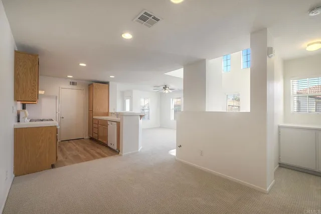 a view of a kitchen with a sink and cabinets