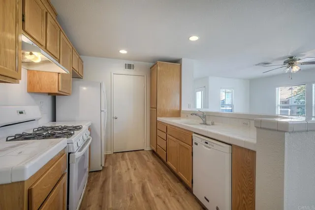 a kitchen with sink stove and refrigerator
