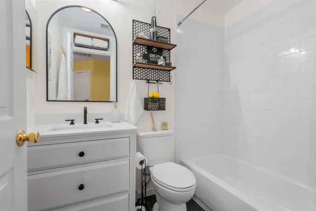 a bathroom with a sink a toilet and mirror