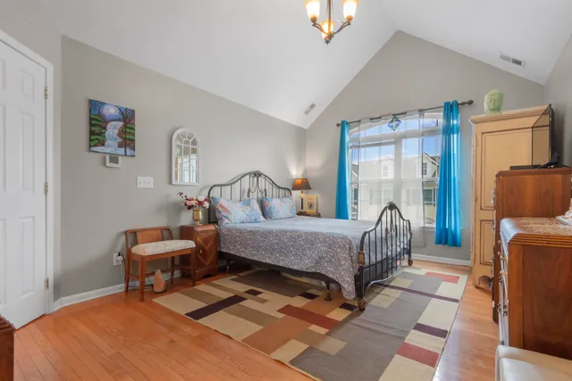 a bedroom with furniture and wooden floor