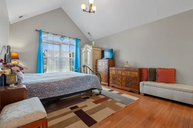 a bedroom with furniture and a wooden floor