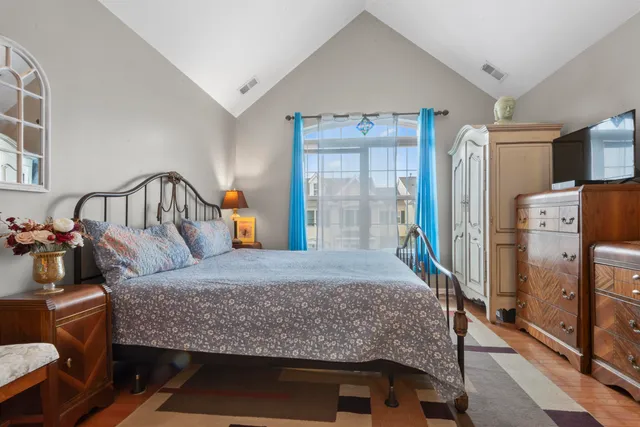 a bedroom with a large bed and a dresser