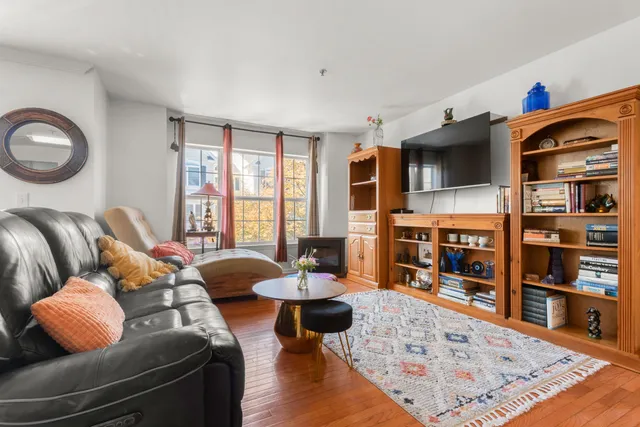 a living room with furniture and a book shelf
