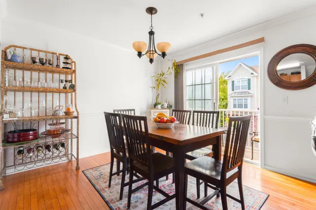 a dining room with furniture a chandelier and wooden floor