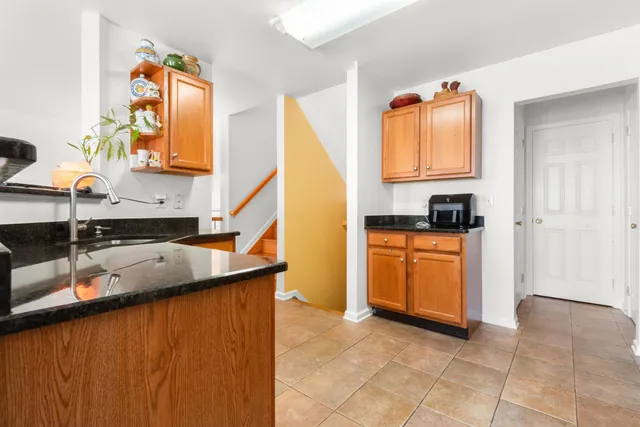 a kitchen with stainless steel appliances granite countertop a sink and a stove