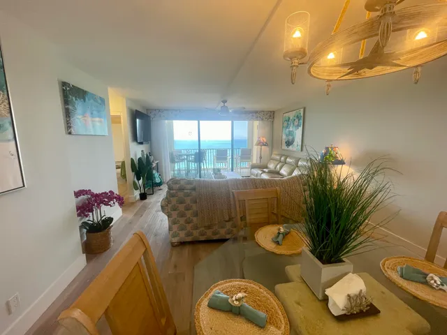 a view of a dining room with furniture wooden floor and chandelier