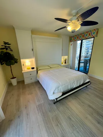 a bedroom with a bed and a view of kitchen