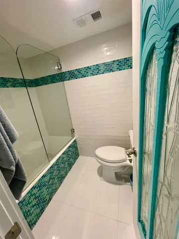 en suite bathroom with granite countertop sink and a mirror