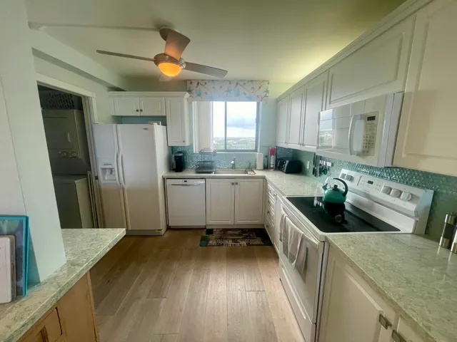 a large bathroom with a granite countertop double vanity sink and a mirror