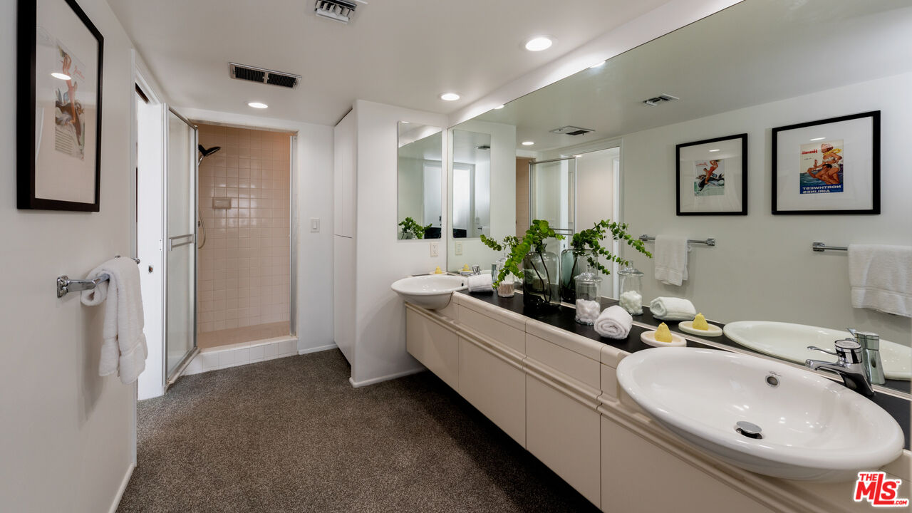 20 Voyage Street Marina del Rey, CA 90292 - Photo 13 of 28 a bathroom with sink mirror and shower
