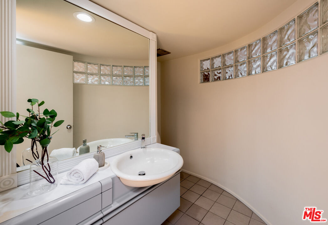 20 Voyage Street Marina del Rey, CA 90292 - Photo 9 of 28 a bathroom with a sink a mirror and a potted plant
