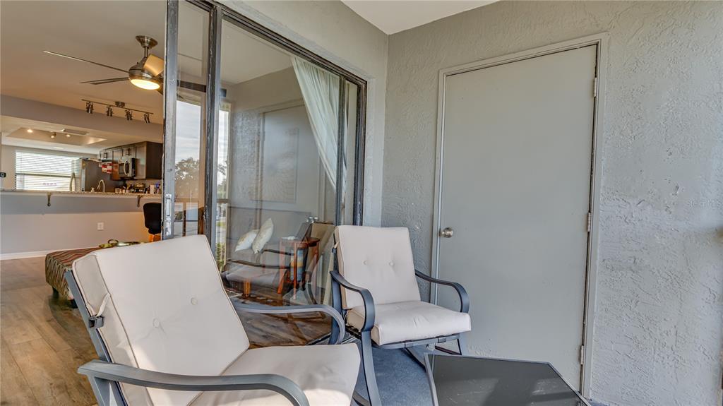 6145 113th Street, Unit 415 Seminole, FL 33772 - Photo 12 of 35 a dining room with furniture and wooden floor