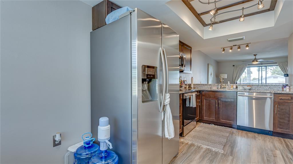 6145 113th Street, Unit 415 Seminole, FL 33772 - Photo 17 of 35 a kitchen with refrigerator and cabinets