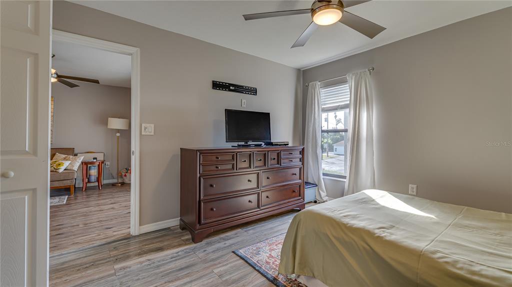 6145 113th Street, Unit 415 Seminole, FL 33772 - Photo 22 of 35 a bedroom with a bed and a television