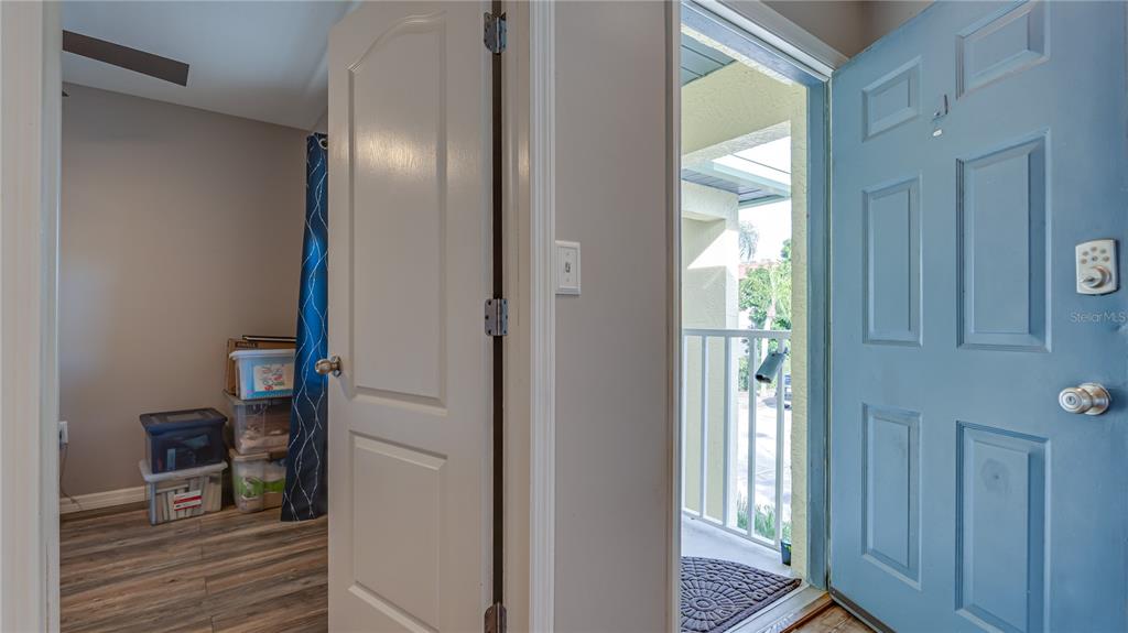 6145 113th Street, Unit 415 Seminole, FL 33772 - Photo 26 of 35 a view of a hallway with wooden floor and entryway