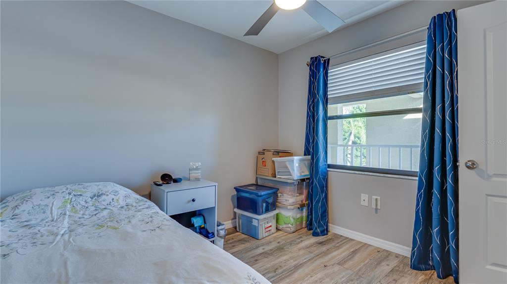 6145 113th Street, Unit 415 Seminole, FL 33772 - Photo 29 of 35 a bedroom with a bed and a window