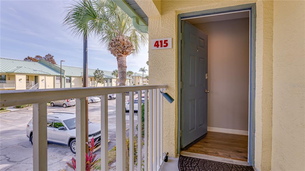 6145 113th Street, Unit 415 Seminole, FL 33772 - Photo 3 of 35 a front view of a house with outdoor space and parking
