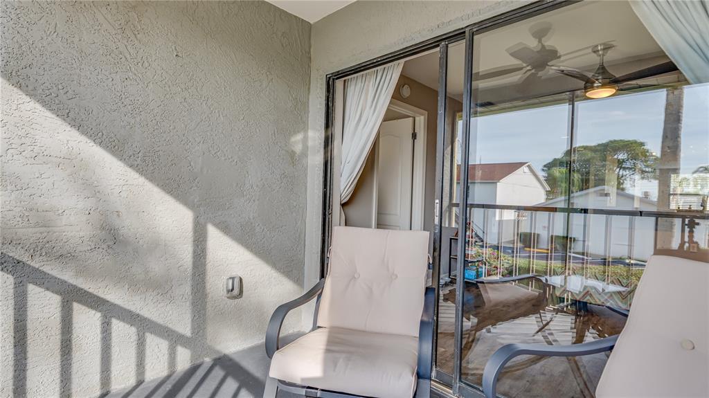 6145 113th Street, Unit 415 Seminole, FL 33772 - Photo 32 of 35 a view of entryway and hall with wooden floor