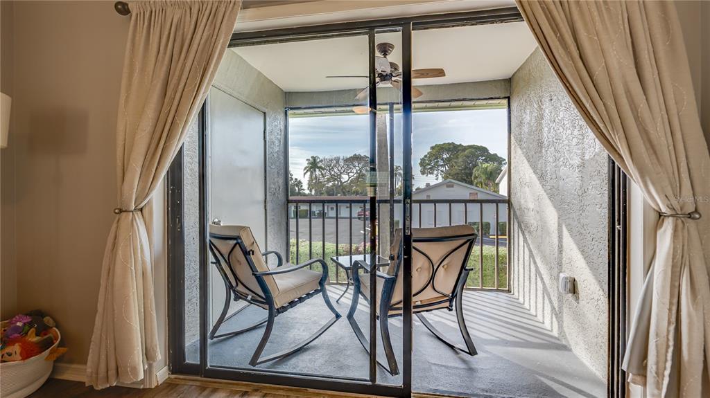 6145 113th Street, Unit 415 Seminole, FL 33772 - Photo 33 of 35 a view of a porch with furniture and wooden deck